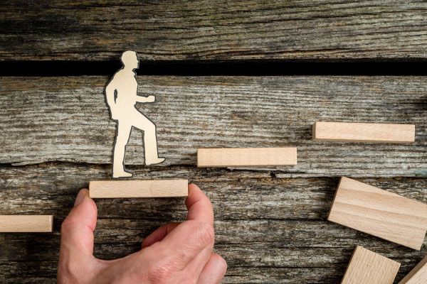 cutout of a man walking up steps